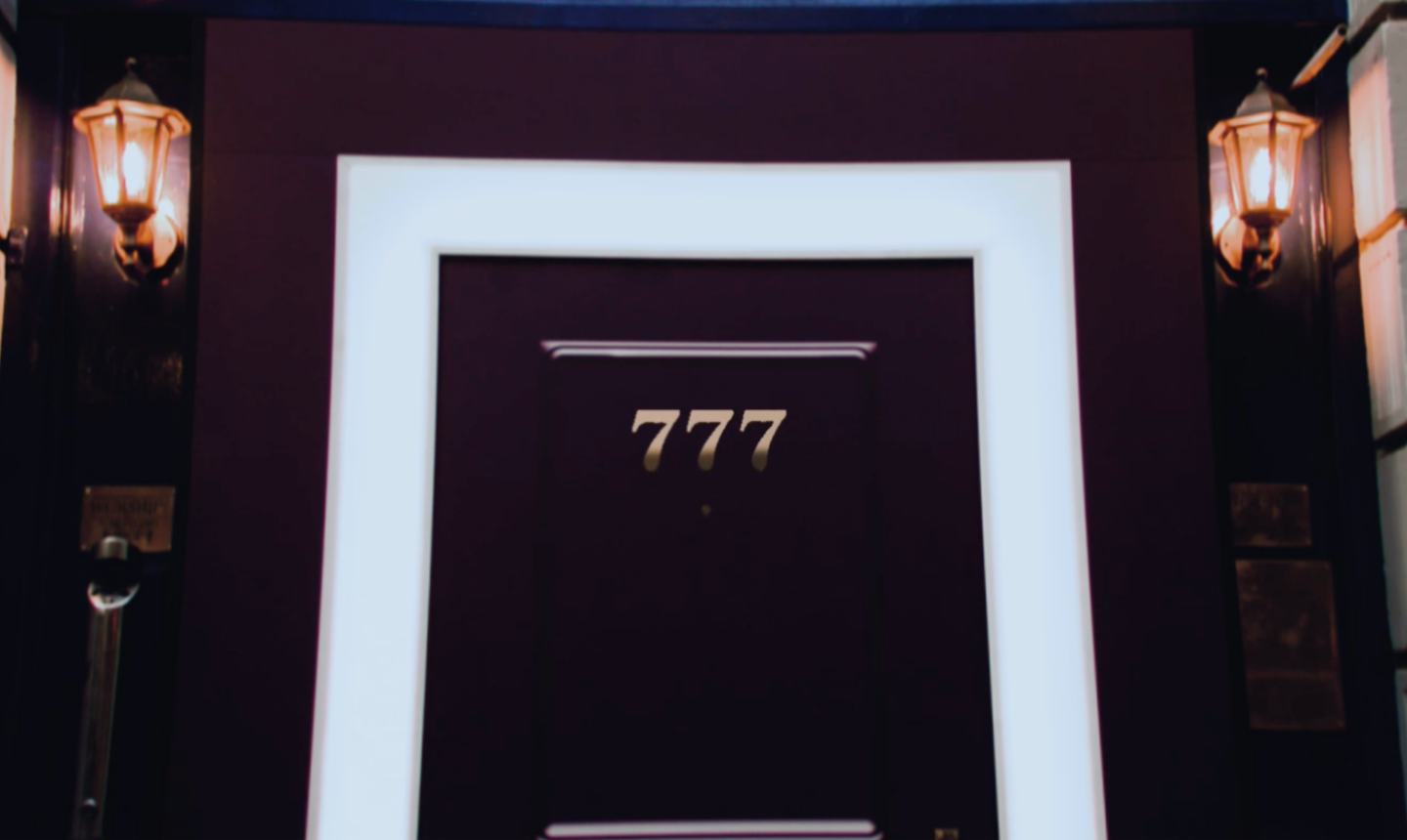 Image of door with three gold sevens as address on door