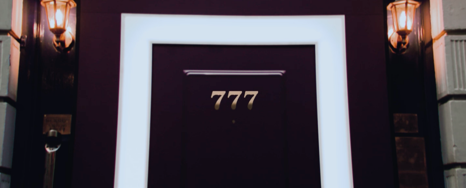 Image of door with three gold sevens as address on door