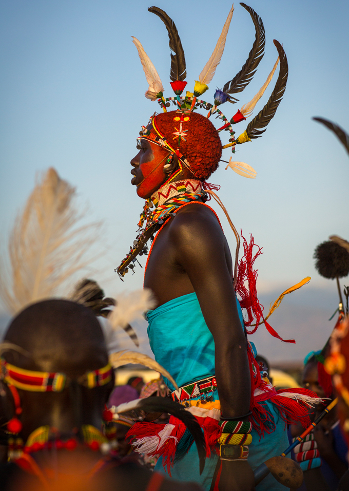 Kenyan with feathered head piece wearing traditional clothing
