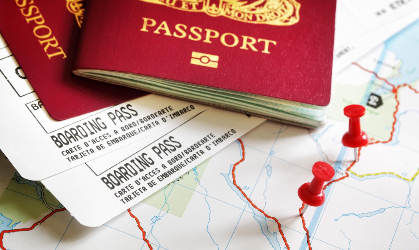 Boarding pass and passport on map with thumbtack concept for travel and vacations