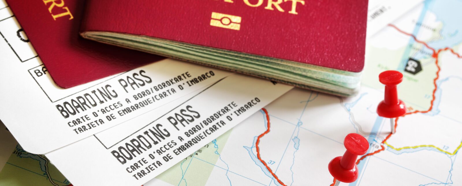 Boarding pass and passport on map with thumbtack concept for travel and vacations