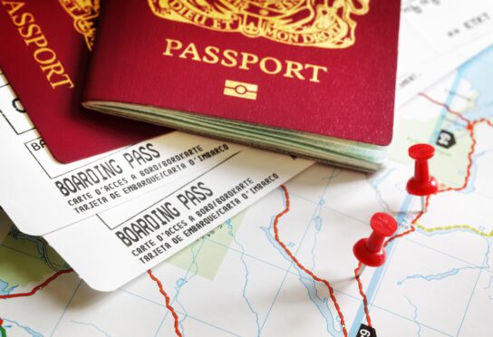 Boarding pass and passport on map with thumbtack concept for travel and vacations