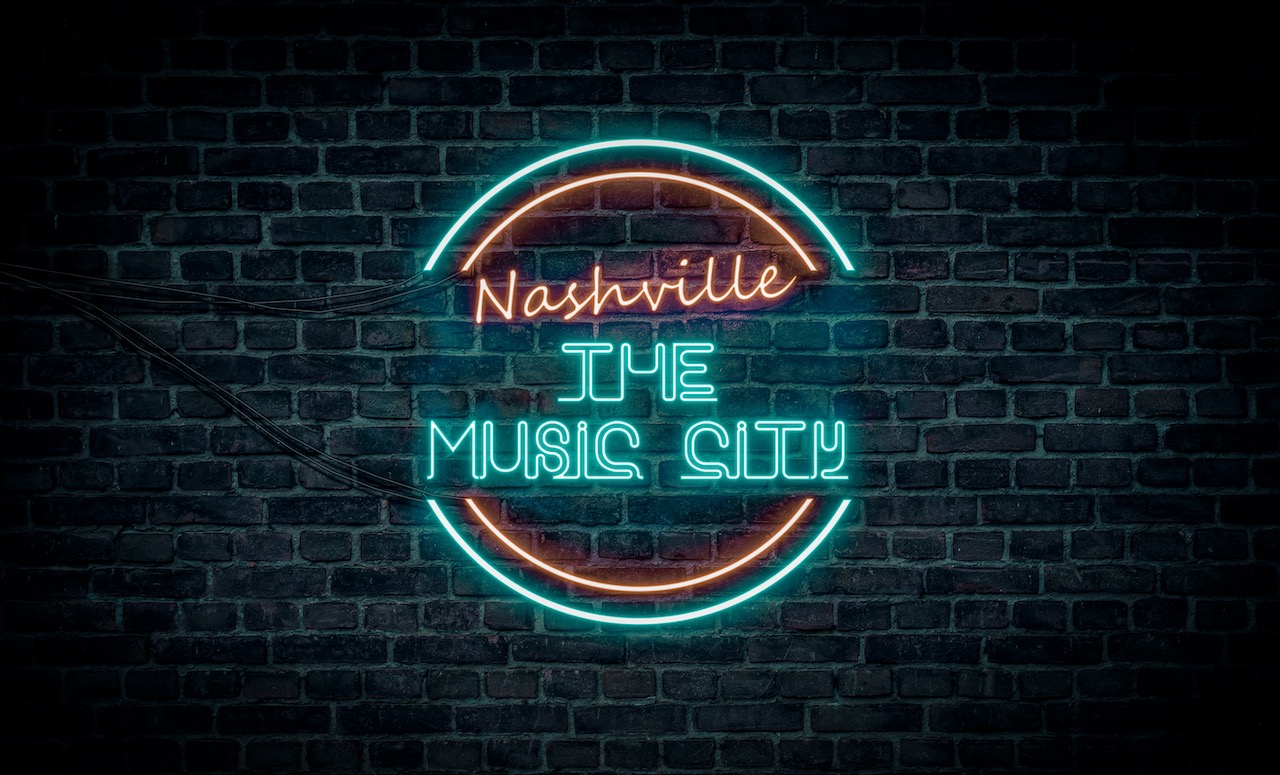 A red and blue neon light sign that reads: Nashville the music city