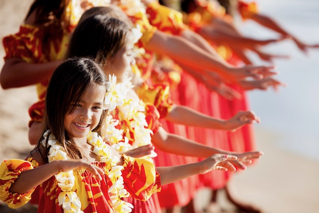 Hula girls on the beach with Hands raised