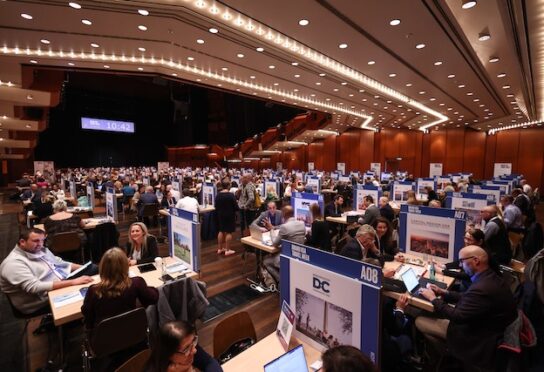 A side view of a large sum of people at a 'Brand USA Travel Week