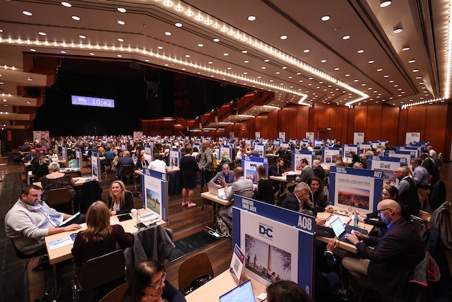 A side view of a large sum of people at a 'Brand USA Travel Week