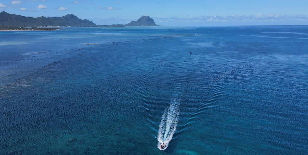 World Ocean Day. small boat or jet ski in the middle of the ocean.