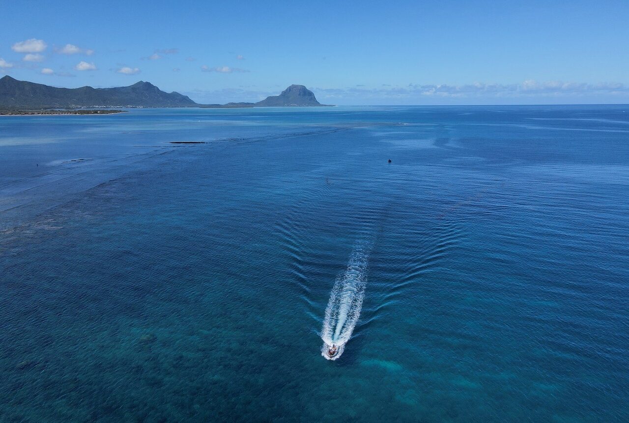 World Ocean Day. small boat or jet ski in the middle of the ocean.